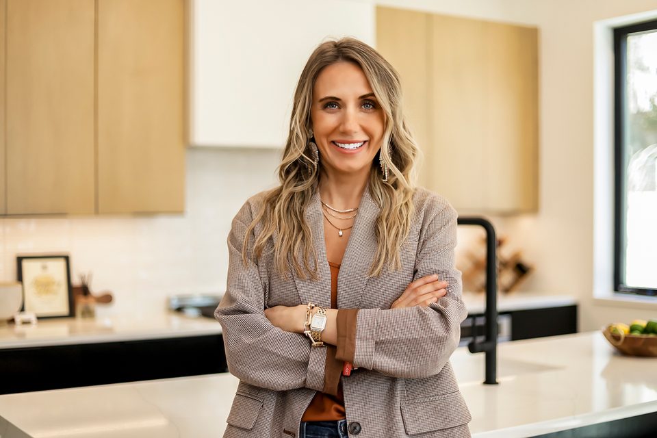 A branding portrait of a real estate professional in a kitchen